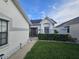 A welcoming walkway leads to the front entrance of this charming white home with grey accents at 5661 Parkview Lake Dr, Orlando, FL 32821