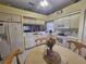 Bright kitchen features white appliances, decorative elements, and an adjacent dining area at 5661 Parkview Lake Dr, Orlando, FL 32821