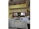 Open kitchen features white cabinetry, a stainless steel sink, and a view into the living area at 5661 Parkview Lake Dr, Orlando, FL 32821