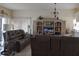 Inviting living room featuring a leather sofa, entertainment center, and plenty of natural light at 5661 Parkview Lake Dr, Orlando, FL 32821