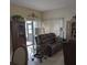 Comfortable living room with a plush leather sofa, decorative furnishings, and sliding glass doors at 5661 Parkview Lake Dr, Orlando, FL 32821