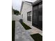 Paved side yard, with low-maintenance artificial turf and gate leading to back at 5661 Parkview Lake Dr, Orlando, FL 32821
