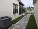 The side yard features stone pavers, artificial turf, and access to a lake view at 5661 Parkview Lake Dr, Orlando, FL 32821