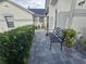A paved walkway along the side of the house, with lush greenery and outdoor seating at 5661 Parkview Lake Dr, Orlando, FL 32821