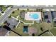 Aerial view of community pool, playground, and parking areas at 568 Meadow Bend Dr, Davenport, FL 33837