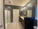 Bathroom features a glass-door shower, sink with vanity, and tile flooring at 568 Meadow Bend Dr, Davenport, FL 33837
