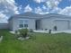 Charming single-story home featuring a gray exterior, a two-car garage, and well-maintained landscaping at 568 Meadow Bend Dr, Davenport, FL 33837