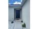 Close-up of the home's front door with a concrete walkway and well-maintained landscaping at 568 Meadow Bend Dr, Davenport, FL 33837