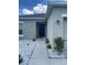 Close-up of the home's front door with a concrete walkway and well-maintained landscaping at 568 Meadow Bend Dr, Davenport, FL 33837