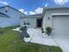 Landscaped front yard with white rocks, green plants and a walkway leading to the black front door at 568 Meadow Bend Dr, Davenport, FL 33837