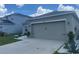View of the garage and front yard showcasing modern landscaping at 568 Meadow Bend Dr, Davenport, FL 33837