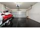 Spacious garage with sleek epoxy flooring and ample room for parking and storage, complete with a jet ski at 568 Meadow Bend Dr, Davenport, FL 33837