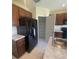 Kitchen features a pantry and stainless steel fridge at 568 Meadow Bend Dr, Davenport, FL 33837