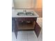 Kitchen island with stainless steel sink and wood cabinets at 568 Meadow Bend Dr, Davenport, FL 33837