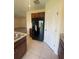 Bright, open kitchen with stainless steel refrigerator and pantry at 568 Meadow Bend Dr, Davenport, FL 33837