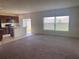 Bright and airy living area with views of the modern kitchen and outdoor space at 568 Meadow Bend Dr, Davenport, FL 33837