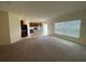 Open-concept living area with kitchen view, ample natural light, and neutral finishes at 568 Meadow Bend Dr, Davenport, FL 33837
