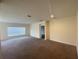 Open-concept living area with neutral walls, carpeting, and abundant natural light at 568 Meadow Bend Dr, Davenport, FL 33837