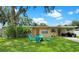 Enjoy outdoor living in this backyard with green grass and outdoor seating at 760 Bearcreek Dr, Bartow, FL 33830