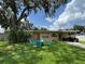 Charming single-story home with a well-manicured front yard and a cozy fire pit area for outdoor enjoyment at 760 Bearcreek Dr, Bartow, FL 33830