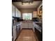 Well-lit kitchen featuring white cabinets, stainless steel appliances, and a window over the sink with a view of greenery at 760 Bearcreek Dr, Bartow, FL 33830