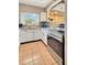 Functional kitchen featuring stainless steel appliances, white cabinets, tile flooring, and a window overlooking the yard at 760 Bearcreek Dr, Bartow, FL 33830