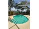 Refreshing screened-in pool, complete with steps and ladder, ideal for relaxing and enjoying sunny days at 760 Bearcreek Dr, Bartow, FL 33830