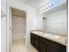 Bright bathroom featuring a double sink vanity with stone counters and a tub with shower at 771 Cavan Dr, Apopka, FL 32703
