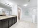 Bathroom with a tub, shower, and vanity featuring granite counters and tile flooring at 771 Cavan Dr, Apopka, FL 32703