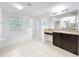 Bright bathroom featuring a walk-in shower, tub, tile flooring, and large vanity with granite counter at 771 Cavan Dr, Apopka, FL 32703