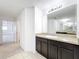 Bathroom vanity featuring granite counters, tile floors, and a large mirror at 771 Cavan Dr, Apopka, FL 32703