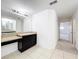 Bathroom vanity with granite counters, tile floors, and a large mirror, in a well-lit space at 771 Cavan Dr, Apopka, FL 32703