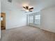 Spacious bedroom with neutral carpet, ceiling fan, and plenty of natural light from two windows at 771 Cavan Dr, Apopka, FL 32703