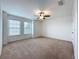 Large, bright bedroom featuring neutral carpet, a ceiling fan, and dual windows for lots of light at 771 Cavan Dr, Apopka, FL 32703