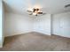 An airy bedroom with neutral carpet, ceiling fan, and a double door closet at 771 Cavan Dr, Apopka, FL 32703