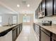 Bright kitchen featuring a center island, stainless steel appliances and tiled floors at 771 Cavan Dr, Apopka, FL 32703