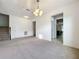 Open living room with neutral carpet, white walls and views to kitchen and stairs at 771 Cavan Dr, Apopka, FL 32703