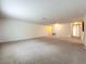 Spacious carpeted living room with neutral walls and access to multiple hallways at 771 Cavan Dr, Apopka, FL 32703