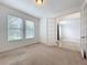 Sunlit office space featuring carpet flooring and glass paneled door at 771 Cavan Dr, Apopka, FL 32703