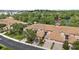 Aerial view of townhouses in a lush neighborhood with lake access and mature landscaping at 8401 Riverdale Ln # 8401, Davenport, FL 33896