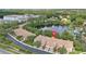 Aerial view of townhouse complex overlooking a lake, surrounded by lush greenery at 8401 Riverdale Ln # 8401, Davenport, FL 33896