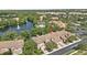 Aerial view of residential area featuring a community pool, a lake and tropical landscaping at 8401 Riverdale Ln # 8401, Davenport, FL 33896