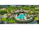 Aerial view of community pool, clubhouse and pond, surrounded by lush landscaping and residential buildings at 8401 Riverdale Ln # 8401, Davenport, FL 33896