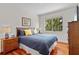 Cozy bedroom with hardwood floors and a large window with green views at 8401 Riverdale Ln # 8401, Davenport, FL 33896