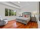 Bright bedroom with a large window, hardwood floors and comfortable furniture at 8401 Riverdale Ln # 8401, Davenport, FL 33896