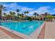 Large community pool featuring a zero-entry access, mature palm trees and plenty of seating at 8401 Riverdale Ln # 8401, Davenport, FL 33896