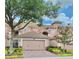 Charming pink two-story home featuring a tile roof, brick driveway, and well-maintained landscaping at 8401 Riverdale Ln # 8401, Davenport, FL 33896
