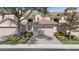 Charming townhome featuring a tile roof, two-car garage, and lush landscaping at 8401 Riverdale Ln # 8401, Davenport, FL 33896