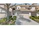 Charming townhome featuring a well-maintained tile roof, two-car garage, and lush landscaping at 8401 Riverdale Ln # 8401, Davenport, FL 33896