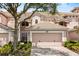 Charming townhome featuring a well-maintained tile roof, two-car garage, and beautifully landscaped front yard at 8401 Riverdale Ln # 8401, Davenport, FL 33896